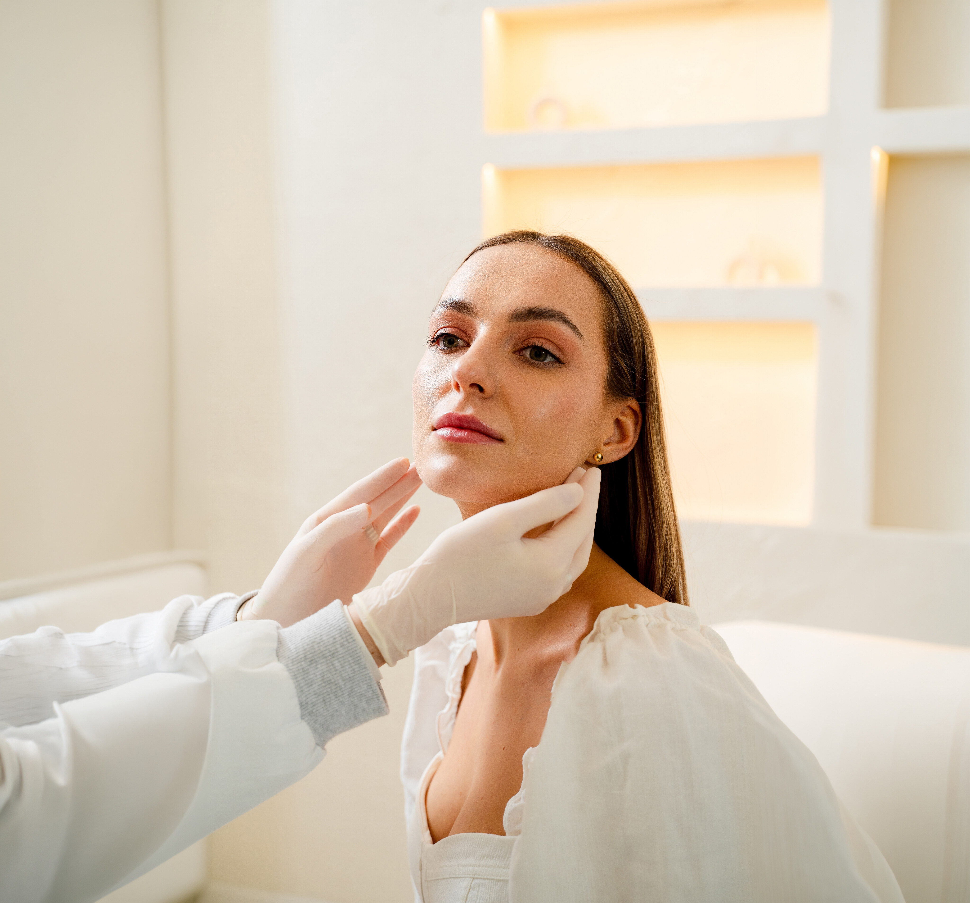 Woman resting her chin on her hand, showing a lifted jawline