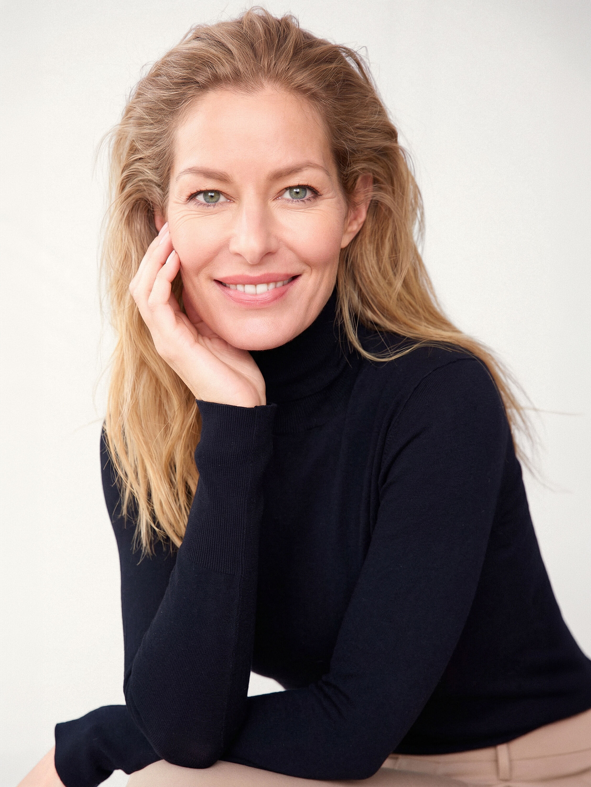 Portrait of a woman in a bright room with a defined jawline and smooth skin